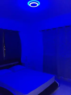 a dark room with a bed with a blue light at Apartamento Llana in Santa Maria