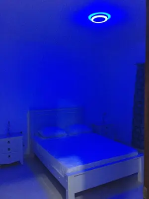 a blue room with a bed with a blue light at Apartamento Llana in Santa Maria