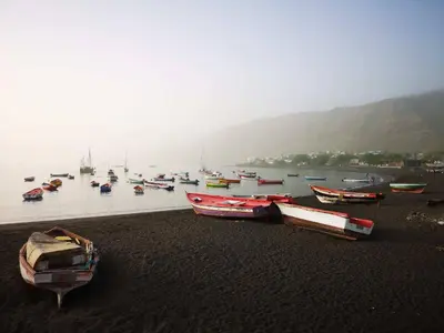 a group of boats on the shore of a body of water at bed & breakfast Regina in Tarrafal