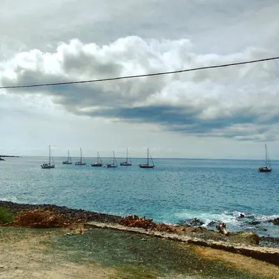 a group of sailboats in the ocean on a cloudy day at bed & breakfast Regina in Tarrafal