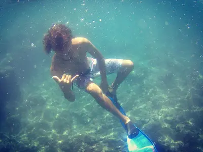 a young man in the water with a paddle at bed & breakfast Regina in Tarrafal