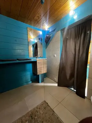 a bathroom with a shower and a mirror at Casa Madeira in Porto Novo