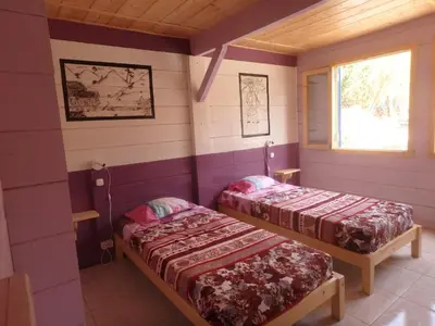 a room with two beds and a window at Casa Madeira in Porto Novo