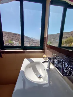 a bathroom with a white sink and two windows at Hotel Belvedere Mindelo, Cabo Verde in Mindelo