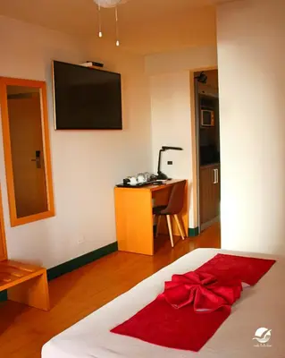 a bedroom with a bed with a red bow on it at Hotel Belvedere Mindelo, Cabo Verde in Mindelo