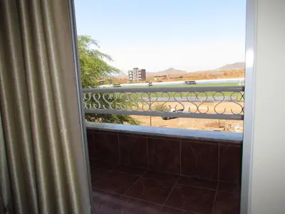 a view from a balcony with a view of a fence at Residêncial Carlos Carvalho in Praia