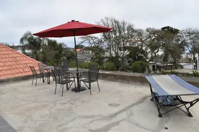 a group of tables and chairs with an umbrella at Villa Vicente in Vila Nova Sintra