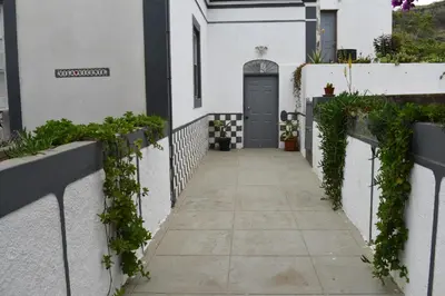 a walkway leading to a door in a white building at Villa Vicente in Vila Nova Sintra