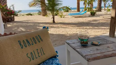 a chair sitting on a table next to a beach at Beachhaus Praia de Chaves in Cabeçadas
