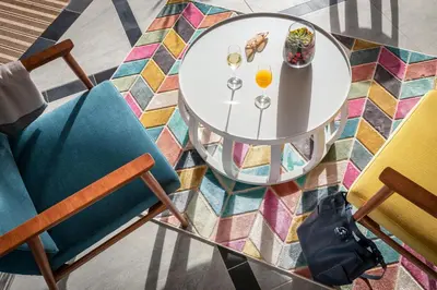 a table with a plate of food and two chairs at ROBINSON Cabo Verde - Adults only in Santa Maria