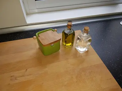 two bottles of oil sitting on top of a table at Casa Io - Bica in Mindelo