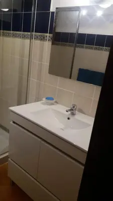 a bathroom with a white sink and a mirror at Oceanfront Apt 4 Porto Antigo II in Santa Maria