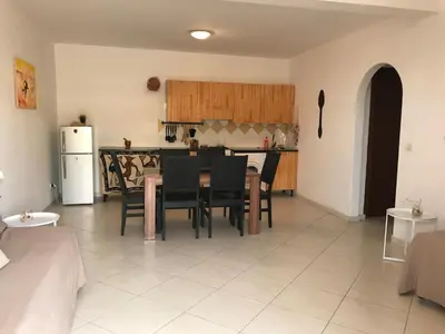 a kitchen and dining room with a table and chairs at Blue Ocean in Santa Maria