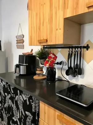 a kitchen with a black counter top with utensils at Blue Ocean in Santa Maria