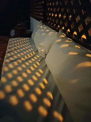 a bed with two white pillows and a shadow at Blue Ocean in Santa Maria