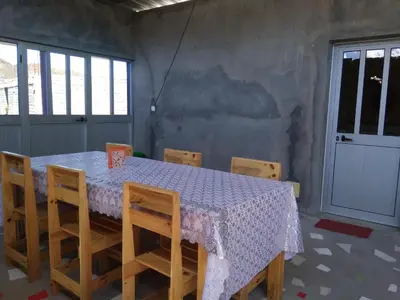 a dining room with a table and chairs and a door at Ciza e Rose in Portela
