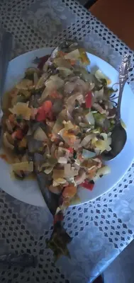a plate of food on a table with a spoon at Ciza e Rose in Portela