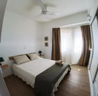 a bedroom with a bed and a ceiling fan at Avenida Dr Baltazar Lopes da Silva 33A in Mindelo