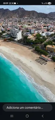 a view of a beach with a city and the ocean at Avenida Dr Baltazar Lopes da Silva 33A in Mindelo