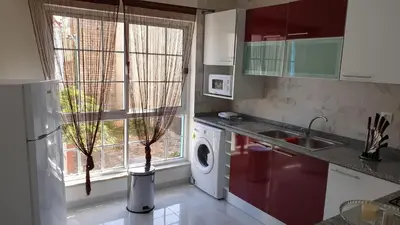 a kitchen with a washing machine and a window at Sonho Appartement in Praia