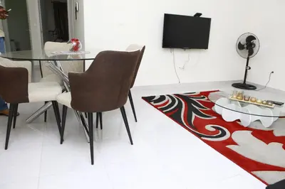 a dining room with a table and a tv at Sonho Appartement in Praia