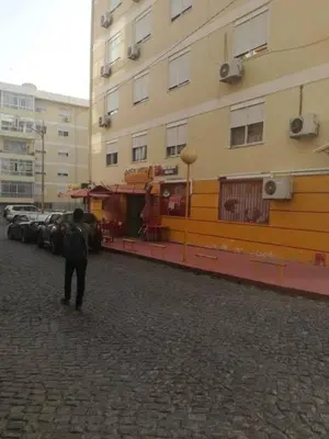 a person walking down a street next to a building at Sonho Appartement in Praia