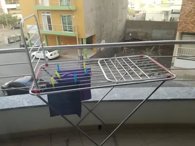 a metal rack on a balcony with toys on it at Appartement de Revé in Praia