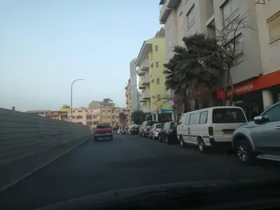 a row of cars parked on a city street at Appartement de Revé in Praia