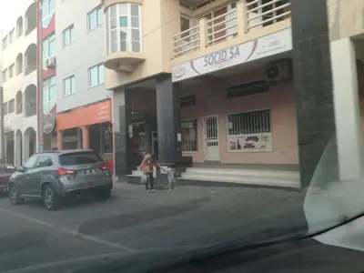 a woman and a child standing in front of a building at Appartement de Revé in Praia