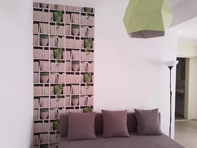 a living room with a couch and a wall with plants at Casa Io - Goraz in Mindelo