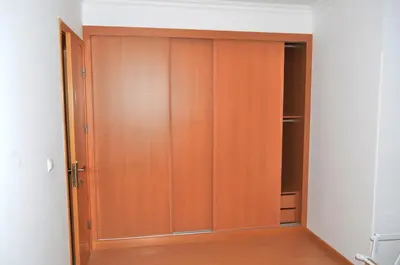 a closet with a wooden door in a room at Apartamento Ireny in Praia