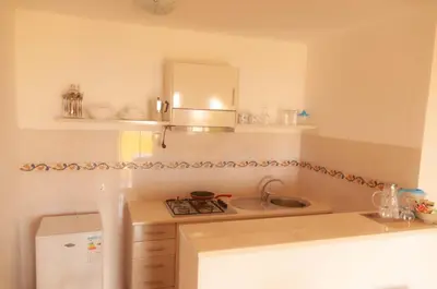 a small kitchen with a sink and a stove at Misturod - Holiday Apartments in Santa Maria