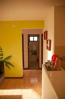 a kitchen with yellow walls and a counter top at Misturod - Holiday Apartments in Santa Maria