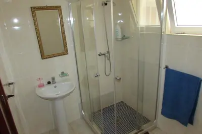 a bathroom with a shower and a sink at Rooming house in Espargos