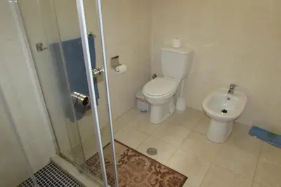 a small bathroom with a toilet and a shower at Rooming house in Espargos