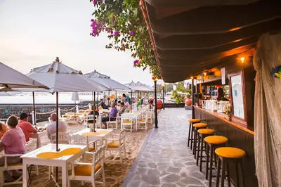 a group of people sitting at tables at a restaurant at Hotel Odjo d'água in Santa Maria