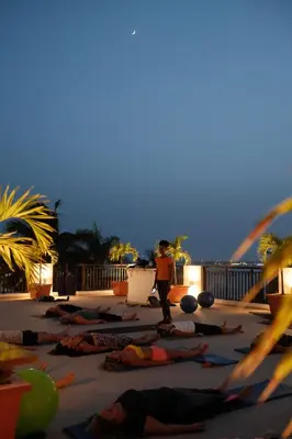 a group of people doing yoga on the beach at Hotel Odjo d'água in Santa Maria