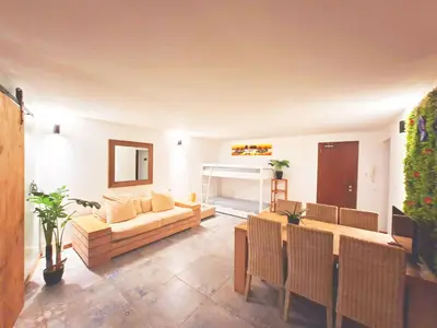 a living room with a couch and a fireplace at Penthouse with rooftopbar, Fiber WiFi, next to the beach! in Santa Maria