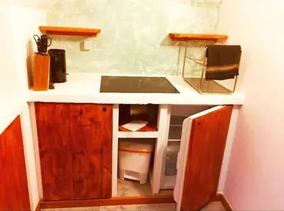 a small kitchen with a counter and a sink at Penthouse with rooftopbar, Fiber WiFi, next to the beach! in Santa Maria