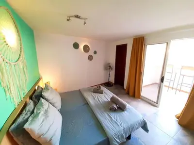 a bedroom with a large bed with pillows on it at Penthouse with rooftopbar, Fiber WiFi, next to the beach! in Santa Maria
