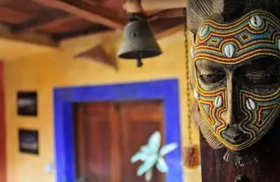 a mask hanging on a wall next to a door at Sakaroule B&B in Santa Maria