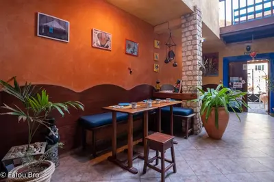 a dining room with a table and some plants at Sakaroule B&B in Santa Maria