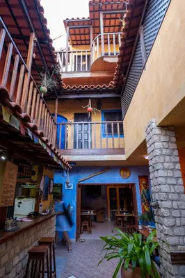 a building with a blue wall with a balcony at Sakaroule B&B in Santa Maria