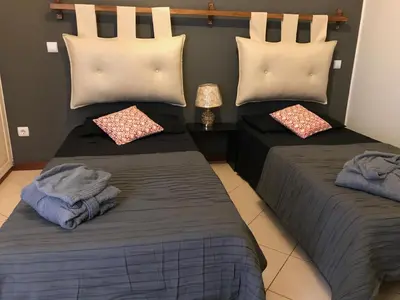 a bedroom with two beds with pillows at Blue Eagle Guesthouse - Casa de hospedes in Santa Maria