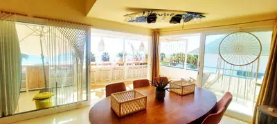 a dining room with a table and a large window at Beach penthouse with rooftopbar and Fiber WiFi, spectacular 180 degrees ocean view in Santa Maria