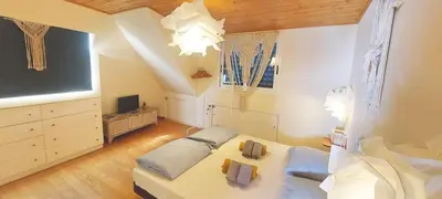 a living room with a couch and a tv at Beach penthouse with rooftopbar and Fiber WiFi, spectacular 180 degrees ocean view in Santa Maria