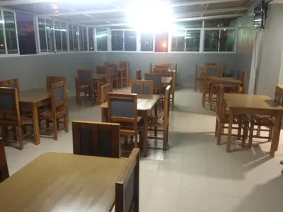 a dining room with tables and chairs and a lot of tables at Pensao Motel Sodade in São Filipe