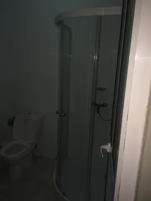 a bathroom with a toilet and a glass shower at Pensao Motel Sodade in São Filipe