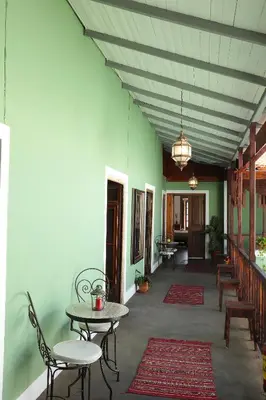 a hallway with tables and chairs in a building at Casa Colonial Koenig in São Filipe