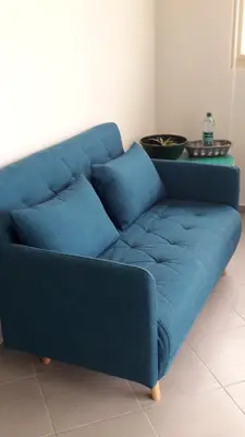 a blue couch sitting in a living room at B&B Sereia Azul Boa Vista in Sal Rei